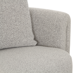 Designer armchair with soft boucle upholstery, stylish grey finish, and comfortable modern seating