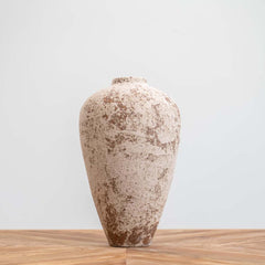 Handmade African-inspired urn with earthy metallic finish and peeling effect, ideal as a rustic centerpiece for tables or consoles.