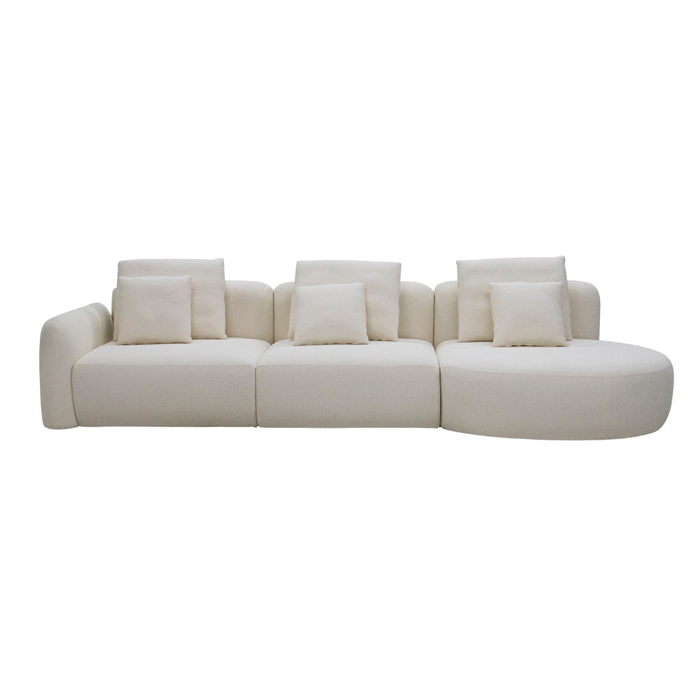 A 3.35-meter Vihta sectional sofa upholstered in soft woven fabric, featuring a rounded moon-shaped chaise in a bright, minimalist living room with natural light.