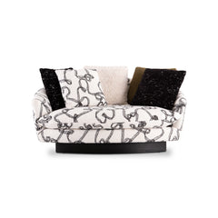 Contemporary small sofa with soft curved silhouette, boucle-inspired fabric, and layered cushions, ideal for stylish modern living spaces.
