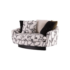 Compact designer lounge sofa upholstered in black-and-white abstract boucle fabric with plush scatter cushions for contemporary interiors.
