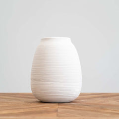Handmade white textured vase featuring linear detailing, ideal for displaying fresh or dried flowers in minimalist interiors.