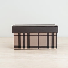 Plaid storage box in warm beige and brown tones with a sleek dark lid for stylish organization