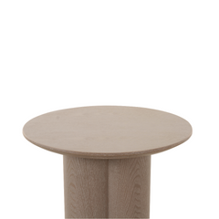 Designer Wyler side table with round surface and petal design legs, combining organic elegance with modern interior style.