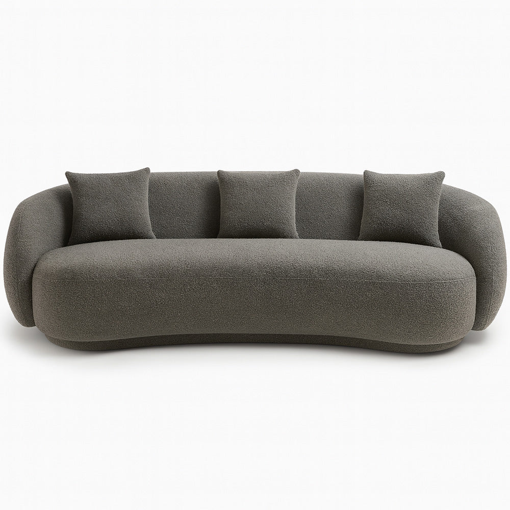 The Zoi 3-Seater Sofa in elegant grey bouclé upholstery, showcasing its modern curved silhouette and plush cushions in a minimalist, contemporary space.