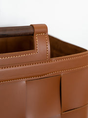 Modern hand-woven green leather storage basket crafted from premium bridle leather, offering a chic and functional solution for living rooms, bedrooms, or offices.