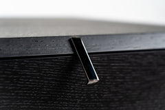 Black bedside table with rotating drawers, sleek modern design, versatile storage furniture
