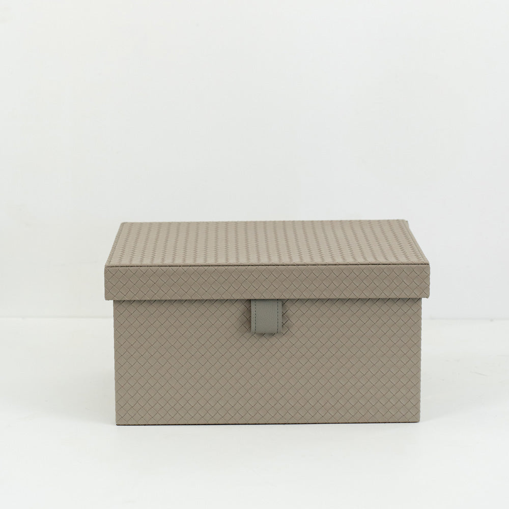 Multiple sizes of Cairn PU leather storage boxes with velvet lining arranged in a minimalist modern room.