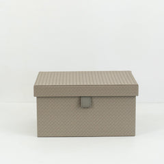 Multiple sizes of Cairn PU leather storage boxes with velvet lining arranged in a minimalist modern room.