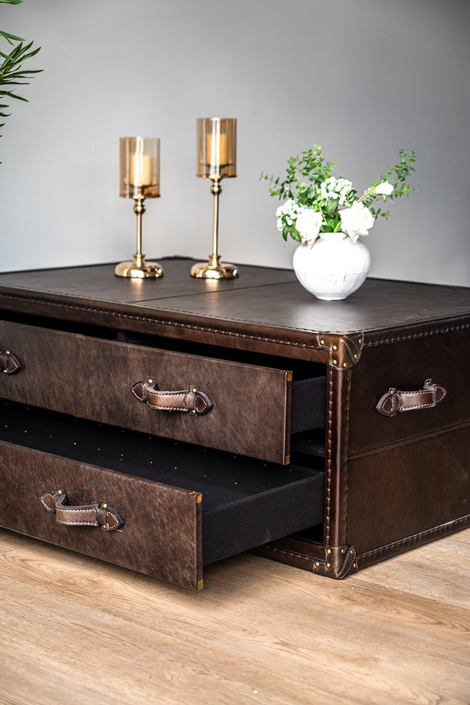 Felix trunk-style coffee table with riveted leather detailing and spacious drawers, elegant and practical