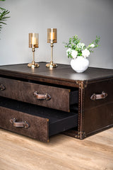 Felix trunk-style coffee table with riveted leather detailing and spacious drawers, elegant and practical