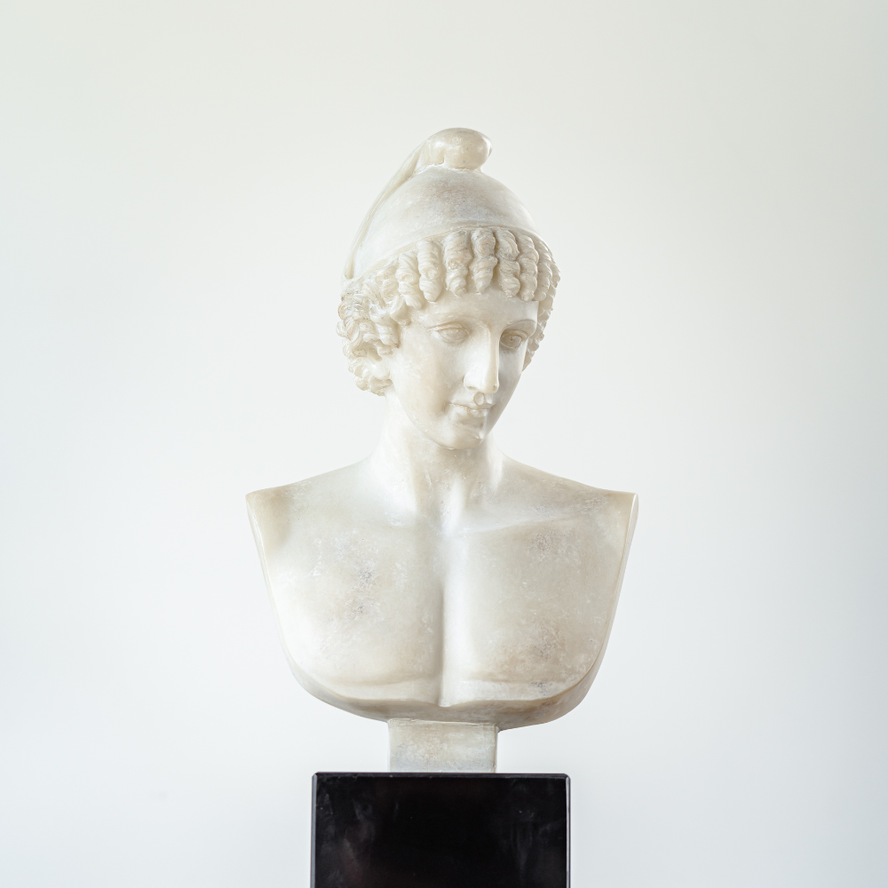 Elegant female bust sculpture crafted from marble and art resin, featuring a woman looking down with serene expression and timeless classical beauty.