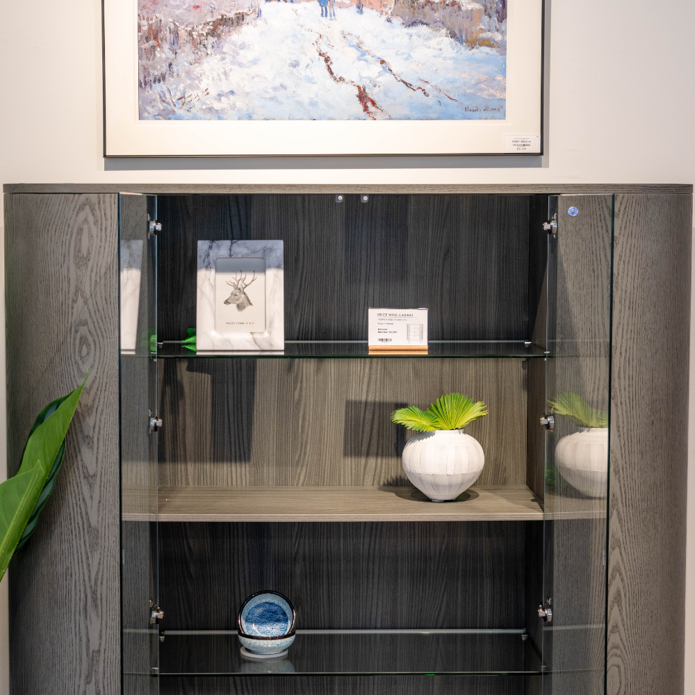 Clear glass door on the Erice cabinet showcasing premium wine bottle arrangement.