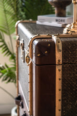 Hereford vintage highboy trunk cabinet featuring three deep drawers, flip-top compartment, and leather finish