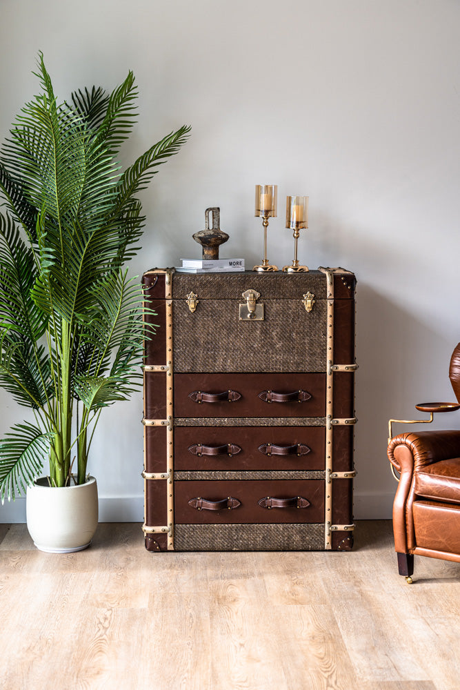 Heritage-inspired Hereford trunk tallboy cabinet with leather wrap, riveted metal edges, and vintage drawer handles