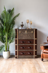 Heritage-inspired Hereford trunk tallboy cabinet with leather wrap, riveted metal edges, and vintage drawer handles