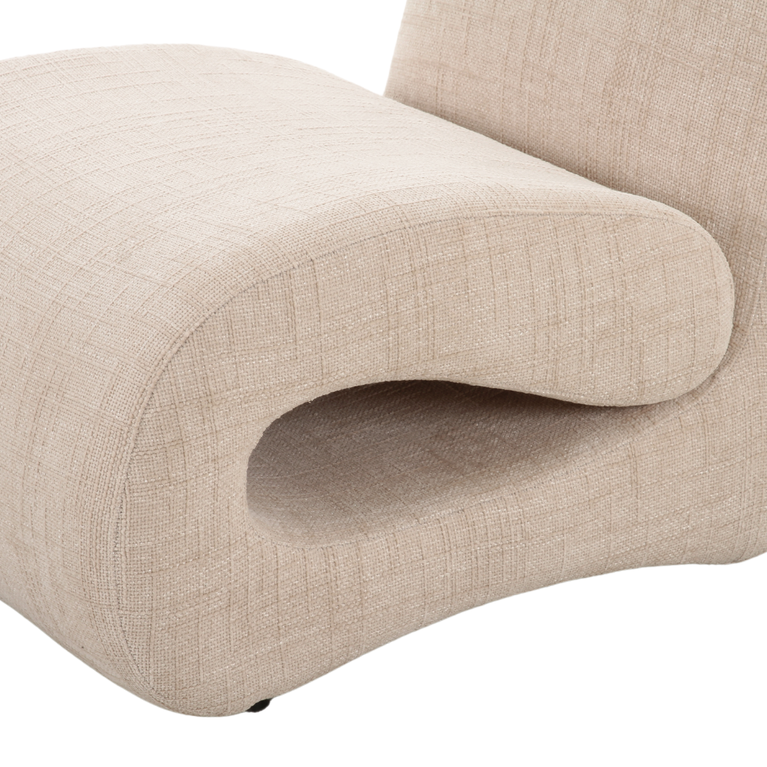 Contemporary armchair with curved silhouette, upholstered in soft fabric