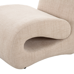 Contemporary armchair with curved silhouette, upholstered in soft fabric