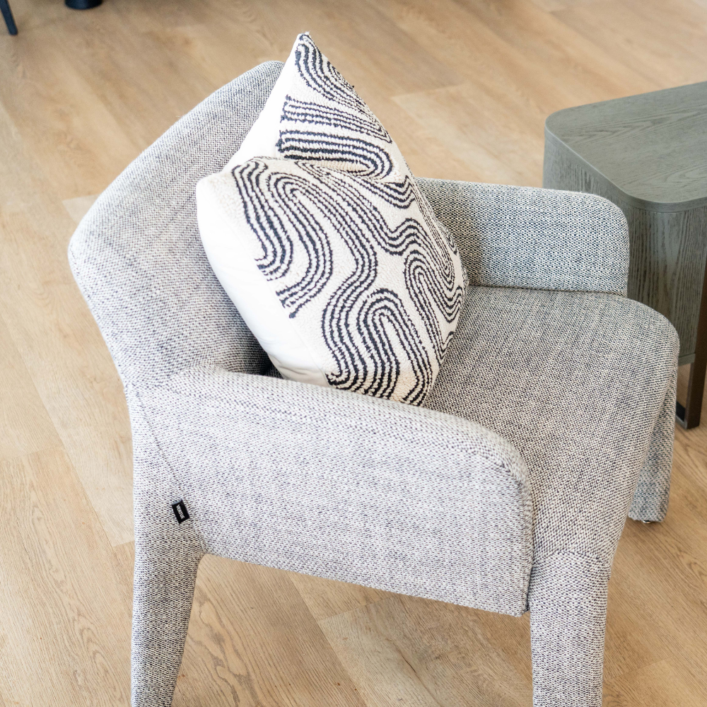 Lulea Armchair upholstered in white and natural cotton blend fabric, modern low back design for contemporary living spaces.