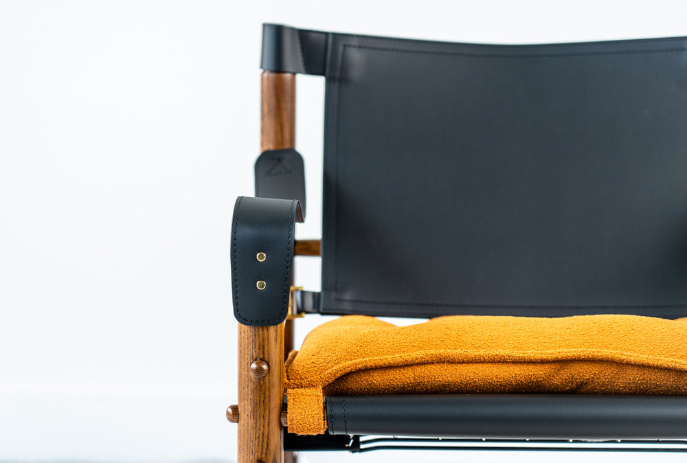Mid-century modern Yorkshire lounge chair crafted with ashwood frame and leather details, stylish designer chair