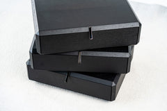 Modern rotating bedside table with black wood finish and swivel drawers, stylish bedroom furniture