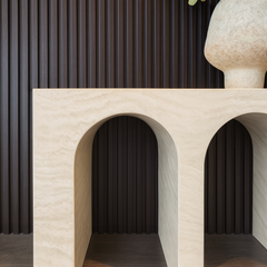 Elegant natural stone travertine console table styled in a living room setting