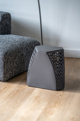 View of the Seggio Stool’s carbon steel legs with openwork design, highlighting structural integrity and visual appeal