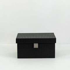 Sutton storage box holding jewelry and accessories, placed on a modern vanity table