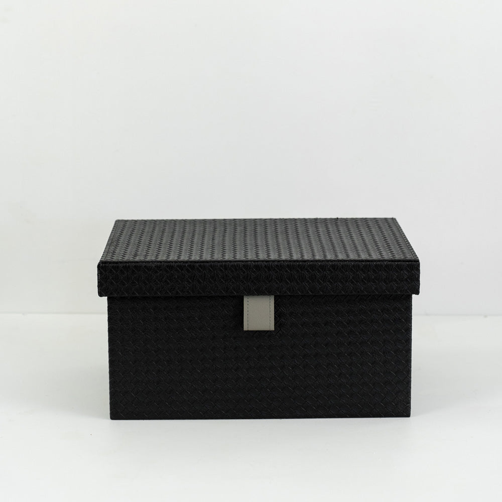 Small, medium, and large Sutton PU leather storage boxes with velvet lining displayed together in a minimalist room