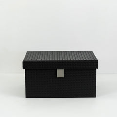 Small, medium, and large Sutton PU leather storage boxes with velvet lining displayed together in a minimalist room