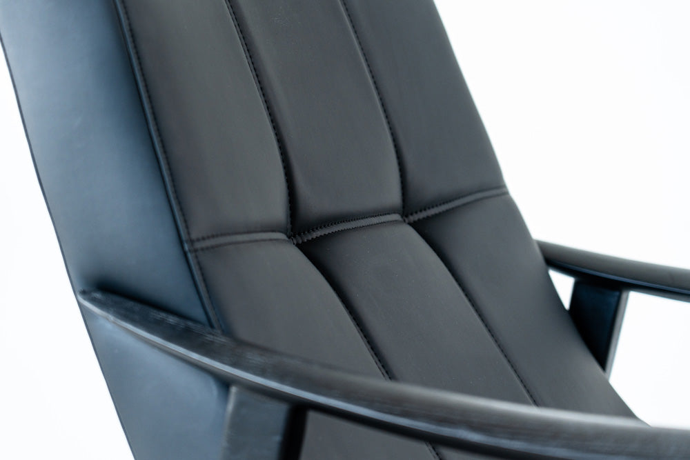 Trani lounge chair in black faux leather with ashwood frame, modern designer seating for living rooms
