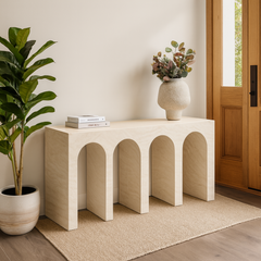 Modern travertine console with architectural arch-inspired design for luxury interiors