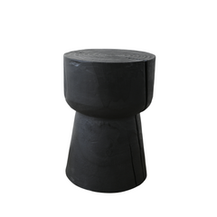 Tucan Side Table crafted from solid Malaysian Pine wood with a dark black oak finish, featuring a round base and smooth round top, styled in a modern living room.