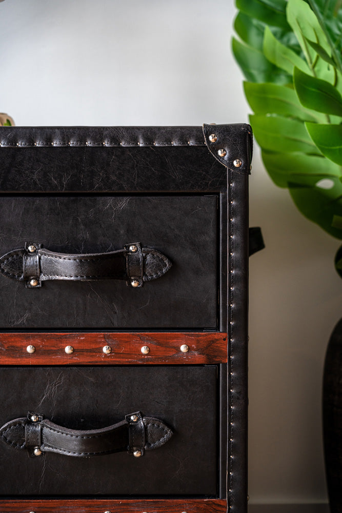 Wells dresser styled as a tallboy with leather wrap, wooden trims, and functional leather straps for decorative appeal